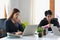 Businesswoman and young businessman using laptop computers at coworking space.