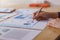 Businesswomen analyzing data financial reports on wooden table