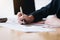 Businesswomen analyzing data financial reports on wooden table