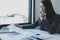 Businesswomen bookkeeper holding graph use calculator and laptop doing account for paying tax on white desk in working office