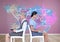 Businesswomen collaborating working in front of Colorful Map with paint splattered wall background