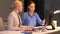 Businesswomen with computer working late at office