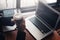 Businesswomen drink hot coffee between working. laptop, calculator and paper on the table