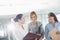 Businesswomen with file folders discussing in office