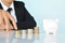 Businesswomen hand walking in coin and white piggy bank