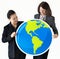 Businesswomen holding globe icon together