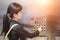 Businesswomen pressing elevator button with sun light effect