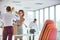 Businesswomen removing tangled cables from box at new office