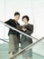 Businesswomen Reviewing Documents On Stairs