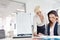 Businesswomen reviewing project at desk in office