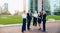 Businesswomen speaking with male boss outside.