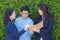 Businesswomen three people looking information on notebook or diary corporate on tree wall.