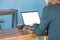 Businesswomen use laptop to find information on working with vintage blue backdrops in coffee shop