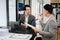 Businesswomen work and discuss their business plans. A Human employee explains and shows her colleague the results paper