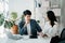 Businesswomen work and discuss their business plans. A Human employee explains and shows her colleague the results paper in modern