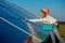 Businesswomen working on checking equipment at solar power plant with tablet checklist, woman working on outdoor at solar power