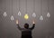 Businness guy in front of idea light bulbs concept