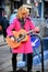 Busker playing Guitar at Portobello Road, London