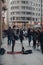 Busker singing and playing guitar on Gran Via street in Madrid, Spain, people walking past