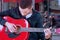 A Busker singing and playing guitar on the streets of old Europe