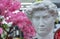 Bust of David by Michelangelo against a background of cherry blossoms