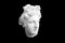 bust head of a woman made of plaster cast isolated on black background. three-quarter position