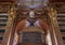 Bust and partial view of bookshelves in the Philosophical Hall, Strahov Monastery Library, Praque