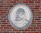 Bust portion of a relief with a Galileo bust and quote on the outside wall of a building at Texas Woman`s University.