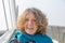 Bust portrait of smiling curly woman on bridge