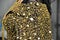bust of woman in black dress with gold sequins in oriental asian style of clothing