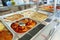 Bustling Cafeteria Serving Line During Lunchtime Offering a Variety of Dishes