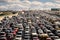 A bustling street filled with a multitude of parked cars creating congestion and limited parking space, Large queue of vehicles on