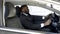 Busy Afro-American man in expensive suit driving to business meeting by car
