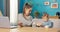 Busy, ambitious girl fills in documents in living room on computer, next to her sits