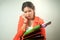 Busy Asian business woman with a lot of folders and colorful papers on background.