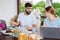 Busy bearded entrepreneur talking to his wife having breakfast