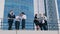 Busy business people outdoors on the terrace of an office building