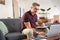 Busy businessman working on laptop at home