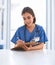 We are always busy. a cheerful young female doctor standing while making notes on a clipboard inside a clinic.