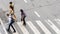 Busy city people move to pedestrian crosswalk on business