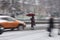 Busy city people on zebra crossing in motion blur. Winter snowy day, dangerous situation