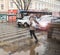 Busy city street people on zebra crossing in a rainy day. Dangerous situation. Defocused image