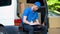 Busy delivery workman counting parcels, stocktaking checklist, part-time job