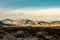 Busy Edge of The Racetrack Playa In Shadow With The Distant Mountains Glowing Gold