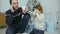 Busy father talking on the phone while with his son drinking cocoa near the Christmas tree