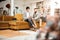 Busy focused couple sitting on brown velvet couch