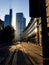 A busy Friday morning London street, with bright sunshine lighting modern buildings