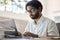 Busy indian business man employee working typing on laptop sitting at desk.