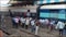 Busy indian train station platform packed with people train arrives, doors open and the crowds move to board train