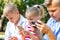 Busy kids looking at their phones texting sms and playing sitting outside